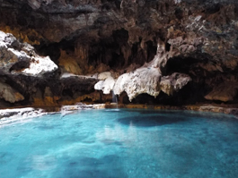 Cave with blue water pool at Cave And Basin National Historic Site