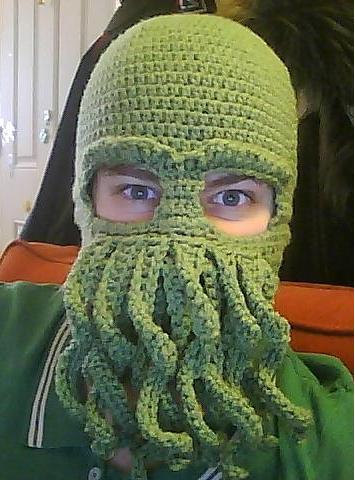 Man wearing a green tentacled Cthulhu ski mask